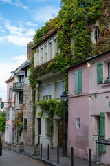 Fototapeta premium Walking on Montmartre hilly historical artistic district of Paris with famous buildings and narrow streets, tourists destination in France