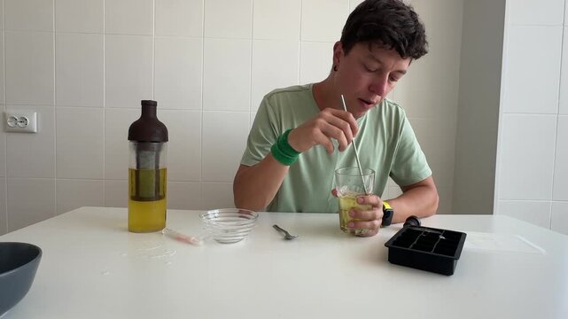 Individual experimenting with glass clothing at kitchen counter