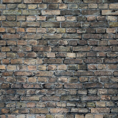 Obraz premium Old brick wall of a building, the photo shows the texture of yellow-brown bricks of the building's facade