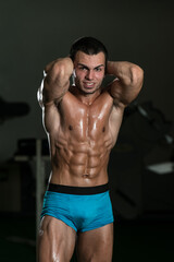 Fototapeta premium Bodybuilder Performing Front Abdominal Thigh Poses