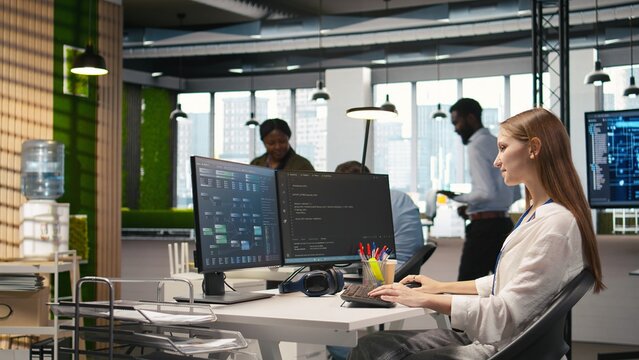 Pleased supervisor recognizing junior dev achievements at work, fostering positive office culture. Cheerful african american manager praising code written by female engineer, doing high five, camera A