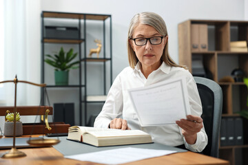Notary working at wooden desk in office