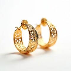 Gold filigree hoop earrings with intricate cutouts shown against clean white backdrop. These ornate jewelry pieces offer luxury and detailed metalwork, perfect for fashion and accessory collections.