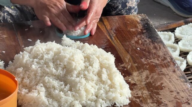 Closeup of a Woman Making Traditional Laos Rice Crackers