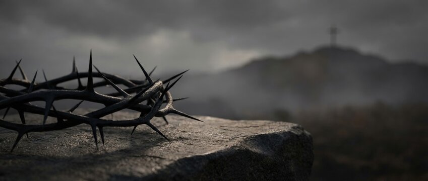 Crown of thorns on a stone with a silhouette of a cross on a hill. Dramatic religious background for Good Friday or Easter. Symbol of the crucifixion of Jesus Christ
