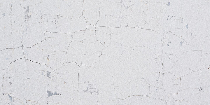 Close up of cracked and peeling white paint on a textured surface