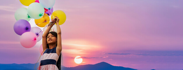 Banner Cheerful cute girl holding balloons run green meadow violet purple pastel sky happiness....