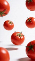 Fresh red tomatoes suspended in mid-air against a clean white background with shadows
