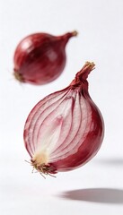 Fresh red onion cut in half, suspended in air against a clean white background