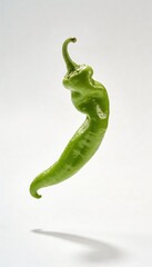 A single green pepper with a curved stem floats against a white background