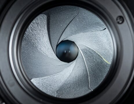 Close-up view of a camera lens aperture blades, showcasing the intricate mechanical design and light control mechanism.