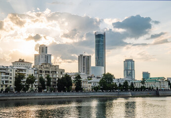Yekaterinburg skyline spanning historic and contemporary architecture lining iset river, glowing...