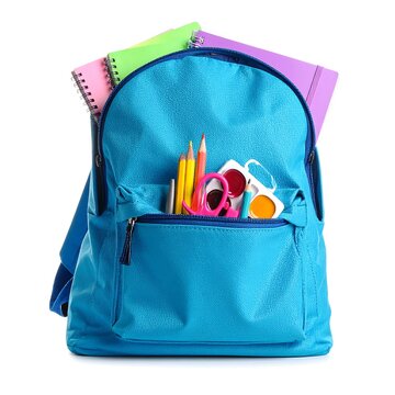 Blue backpack with school supplies on a clean white surface