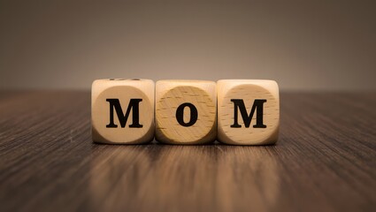 Wooden Blocks Spelling the Word Mom on a Wooden Surface