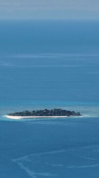 Mantigue Island with white sandy beach and blue sea. Camiguin, Philippines. Vertical, stories.