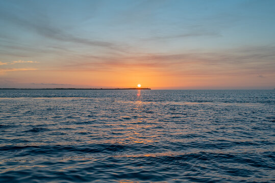 Tropical orange sunrise over ocean