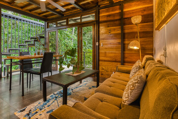 Fototapeta premium Modern tropical living room with rainforest views