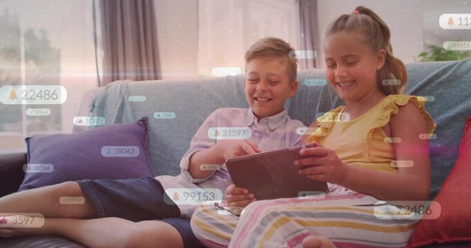 Vertical video: Boy tapping tablet, girl steadying it on couch, edu overlays rising, smiling