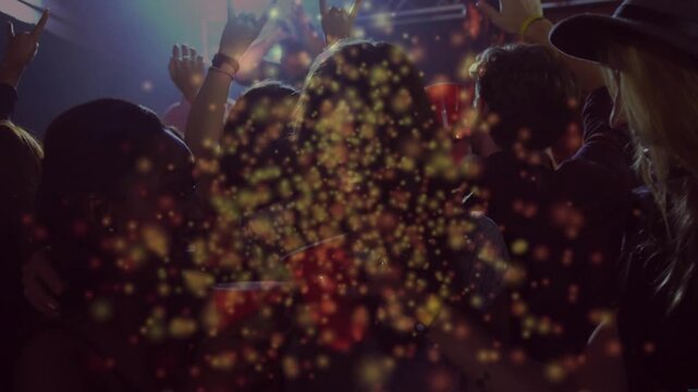 Crowd holding red cups and raising hands as music pulsing, golden sparkles growing dense over heads