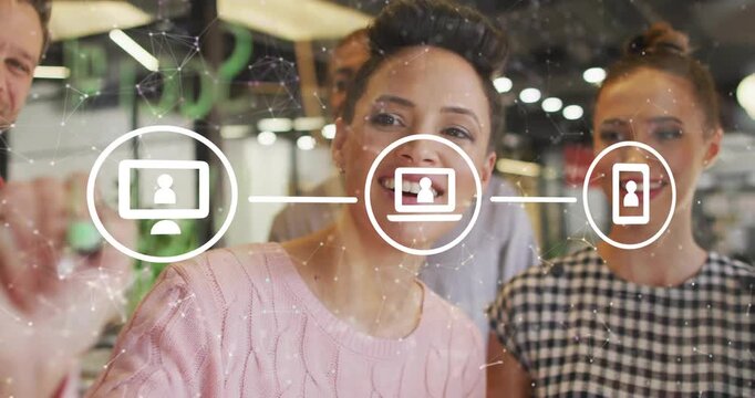 Team of four starting tech brainstorm sketching glass wall and animating monitor laptop phone icons