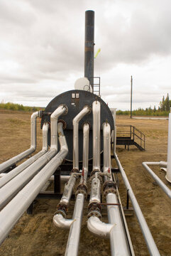 Canada, BC, Fort Saint John.  Pipes and compressor equipment at natural gas pipeline site.