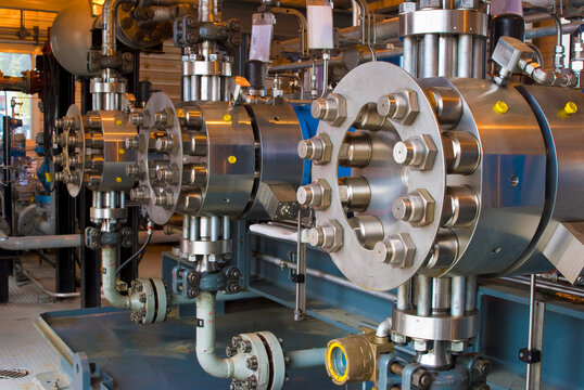 Canada, BC, Fort Saint John.  Stainless steel valve covers and equipment at natural gas compressor site.