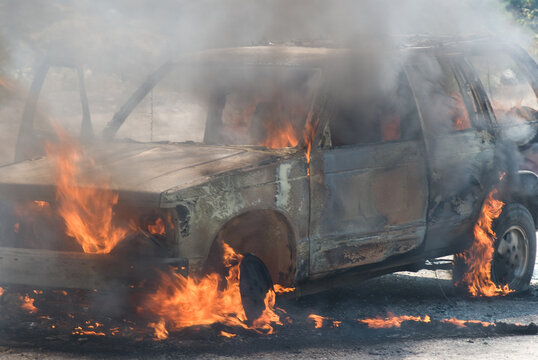 SUV (sport utility vehicle) on fire beside the highway.  Coquihalla Highway, Merritt BC, Canada