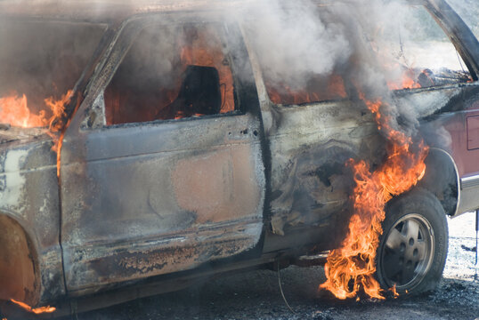 SUV (sport utility vehicle) on fire beside the highway.  Coquihalla Highway, Merritt BC, Canada