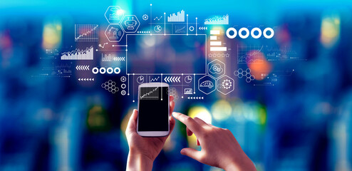 Industry 4.0 theme with person using a smartphone at night