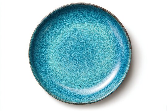 Overhead view of a round textured blue-green ceramic plate with a dark rim on a white background