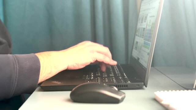 Man typing on laptop keyboard working in home. Freelancer works on a laptop, close - up .Type C.