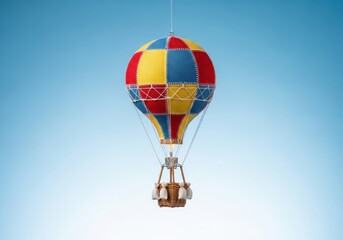 Fototapeta premium Colorful Hot Air Balloon Soars Above Landscape in Clear Blue Sky