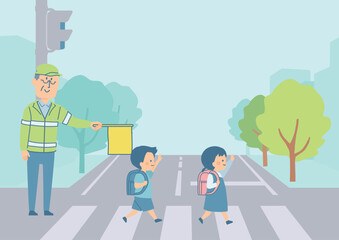 横断歩道を渡る小学生と町の背景