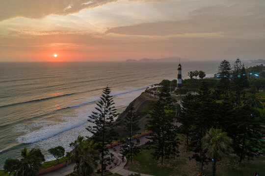 La Marina Lighthouse vibrant sunset golden hour Miraflores Lima Province Peru aerial drone San Miguel de Mira Flores residential historic district Love Park Palomino Island beach ocean tourist locatio