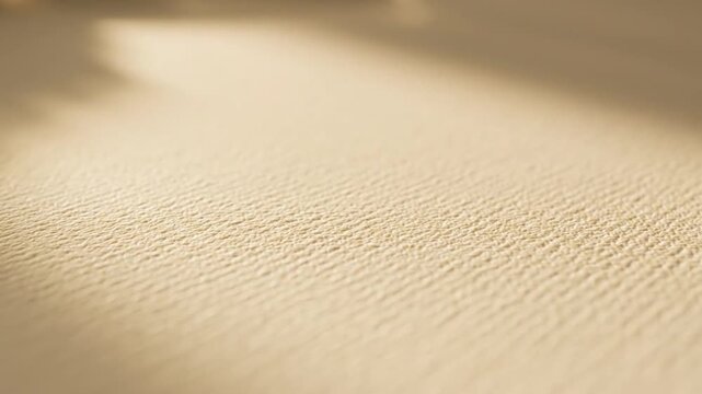 Textured beige paper surface with a diagonal shadow creating depth