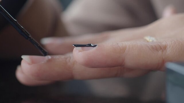 Applying nail polish at a salon in the afternoon