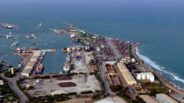 Sunset aerial over North Chennai, casting golden light on Ship Harbour, port and waterfront district, highlighting maritime trade activity, rail connectivity, and dense urban development stretches.