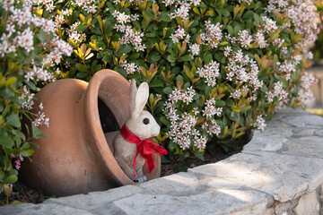 Fototapeta premium Rabbit easter garden decor. Rabbit cute holiday decoration. Rabbit spring festive symbol. Rabbit playful seasonal ornament.