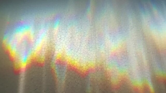 Dynamic Sunlight Refraction Passing Through Water and Casting Sparkling Light Patterns on a White Styrofoam Surface