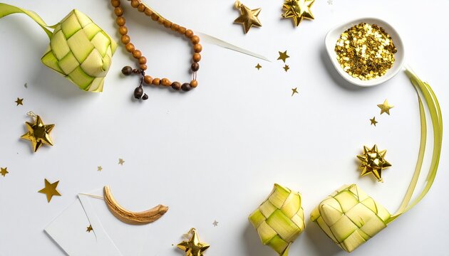 Flat lay composition of Eid decorations- prayer beads, ketupat (rice cakes), greeting