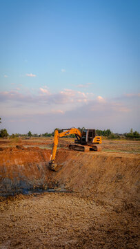 Huai Thalaeng, Thailand &ndash; February 13, 2026 &ndash; A Sany SY135C excavator is working on a pond being dug for agricultural water storage.