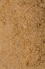 High angle panoramic view of cracked earth surface forming natural polygon patterns under strong...