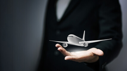 Businessman presenting a virtual airplane model for professional travel and airline service concept. © จุฑารัตน์ เจริญวงษ์