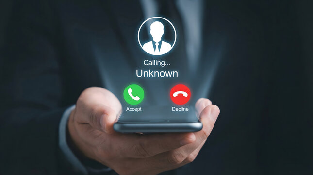 A professional individual holds a smartphone displaying an unknown incoming call screen with accept and declin