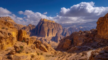 Fototapeta premium Panoramic view of an ancient desert valley with sandstone rock formations and historic architecture under a blue sky for travel guidebooks and adventure tourism