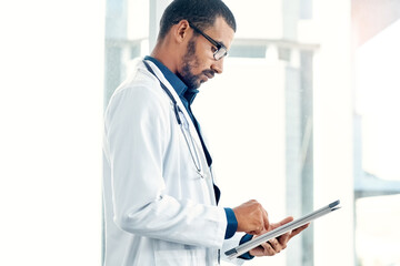 Fototapeta premium Man, online and doctor on tablet in hospital for medical report, research and patient results. Healthcare, clinic and person with digital tech for wellness review, telehealth service and diagnosis