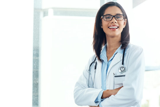 Crossed arms, happy and portrait of doctor in hospital with confidence for medical support. Positive attitude, professional and female surgeon with pride for healthcare service at clinic in Colombia.