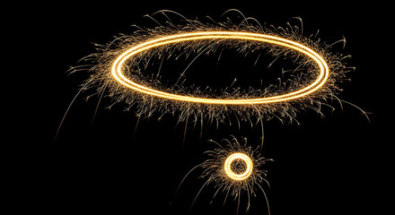 Naklejka premium Golden Ring Of Sparks With Smaller Ring Below On Black Background fireworks
