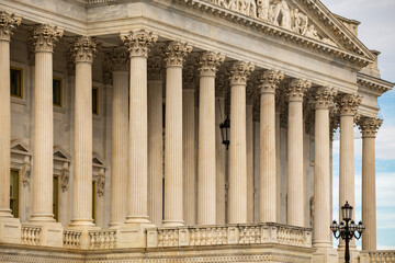 Fototapeta premium Columns architectural heritage marble structure. Columns fluted symmetry perspective. Columns decorative capitals carved detail. Columns neoclassical facade.