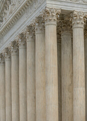Fototapeta premium Columns stone facade architectural symmetry. Columns marble fluted pattern. Columns decorative capitals carved detail. Columns classical.